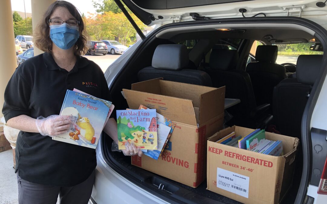 A social worker delivers books donated by kids at FBC Greenwood.